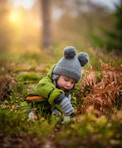 selective focus photo of baby on green grass field