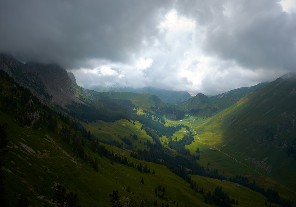 green mountains under cloudy sky