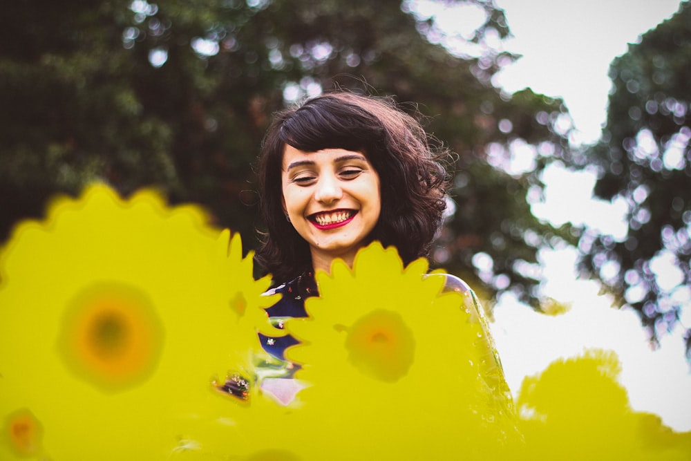 woman standing on yellow flowers