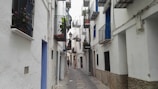 A solo traveler exploring narrow streets filled with white buildings.