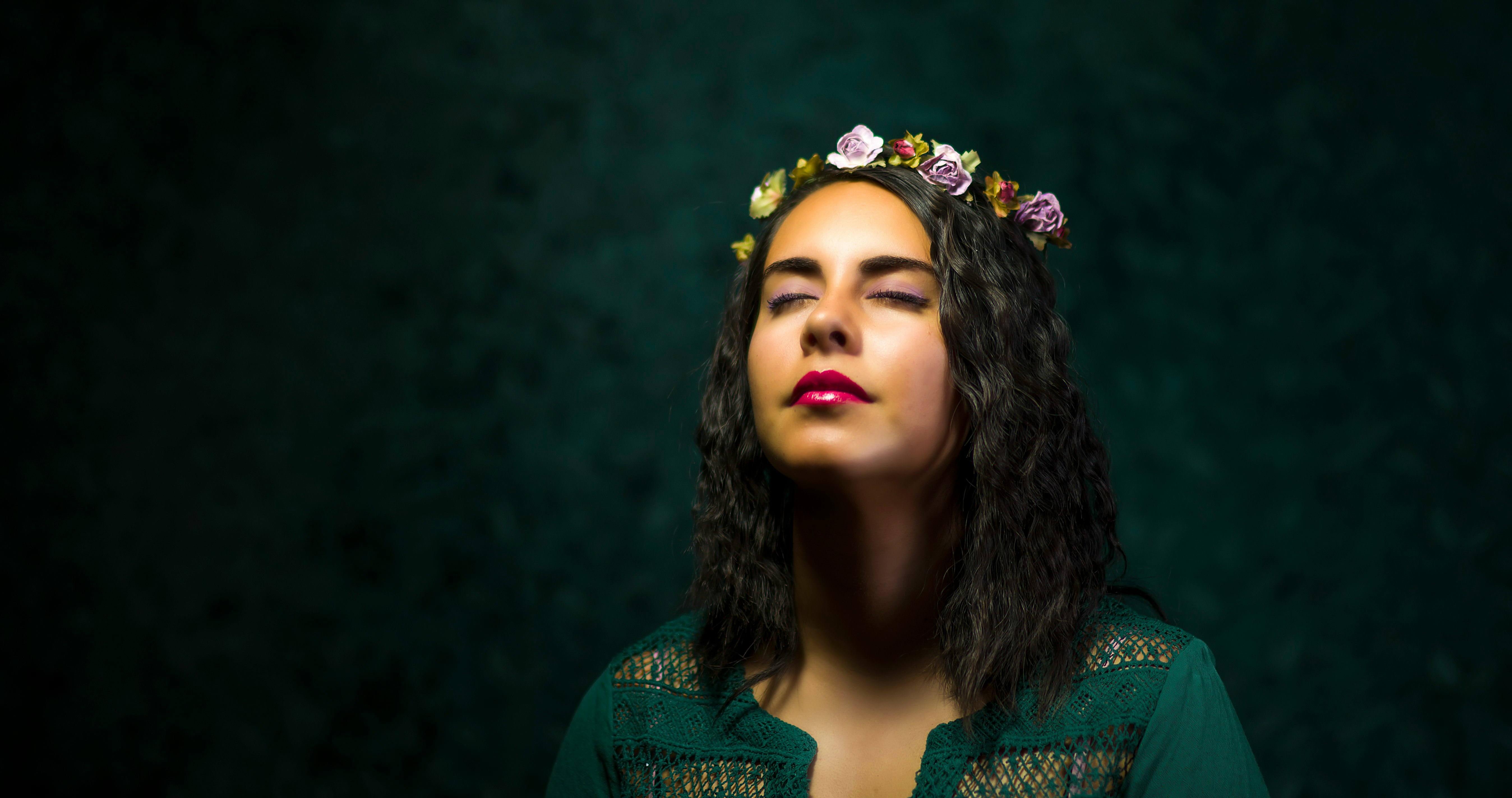 woman in teal top with floral tiara