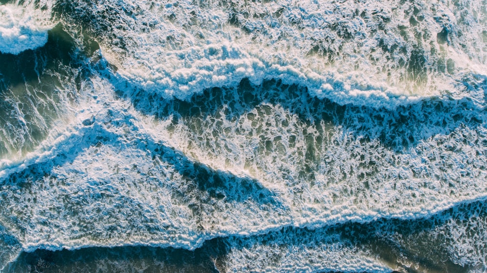 an aerial view of the ocean with waves