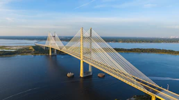 aerial photography of yellow bridge surrounded by body of water