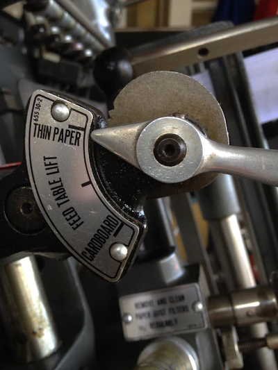 Small industrial machine displayed with clear product description label