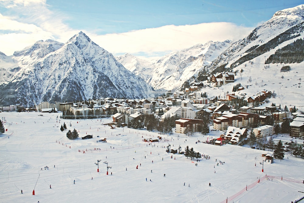 Small village surrounded by mountains and covered by snow