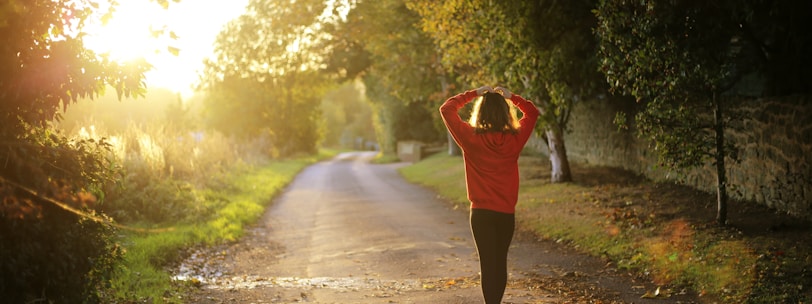 woman walking on pathway during daytime