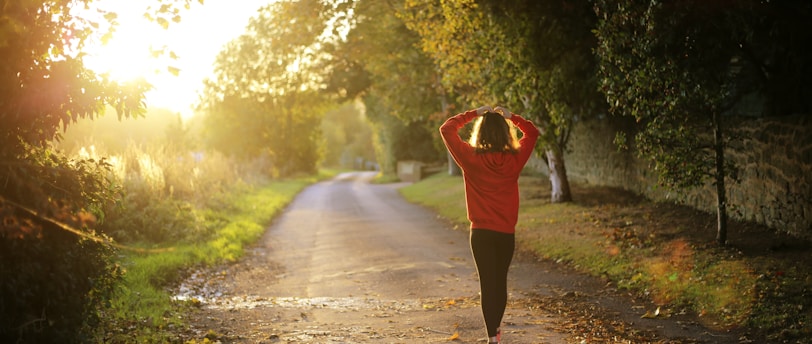 woman walking on pathway during daytime