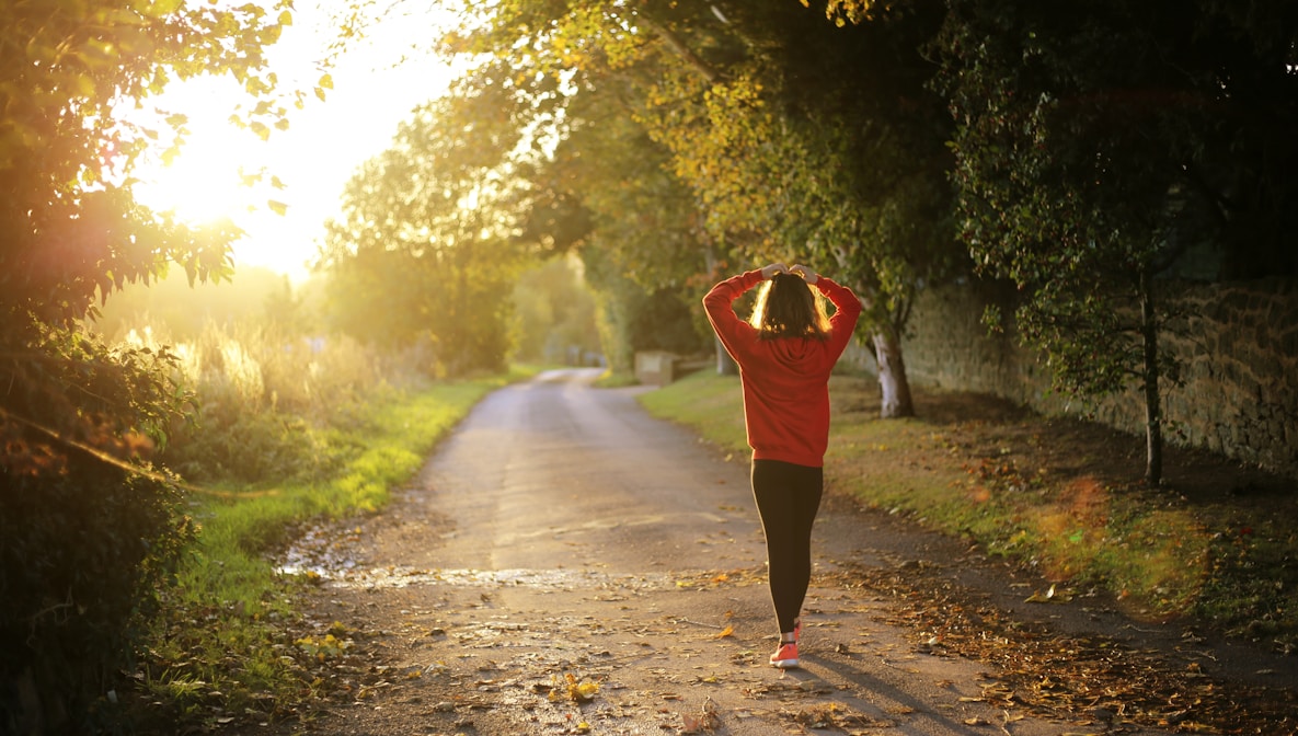 woman walking on pathway during daytime