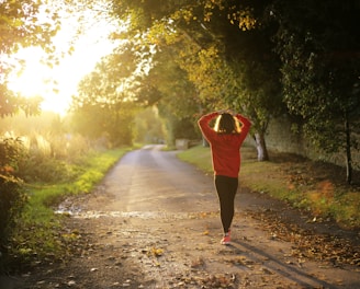 woman walking on pathway during daytime