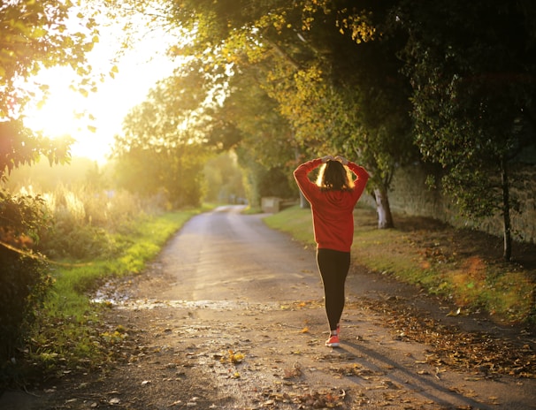 woman walking on pathway during daytime