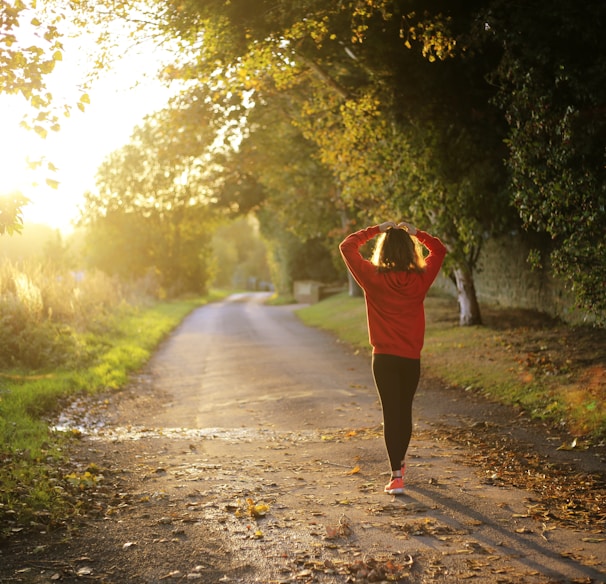 woman walking on pathway during daytime