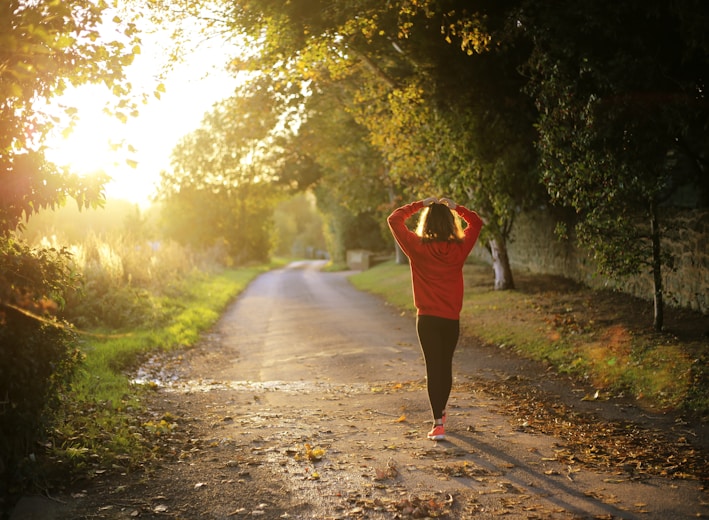 woman walking on pathway during daytime