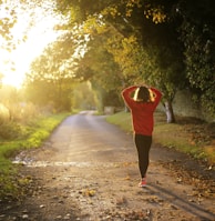 woman walking on pathway during daytime