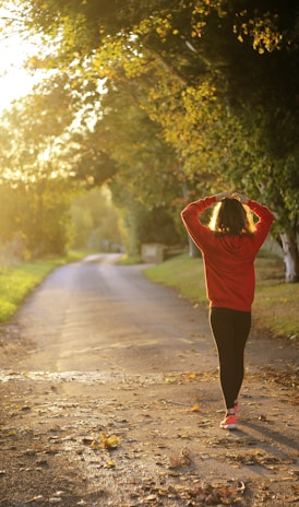 woman walking on pathway during daytime