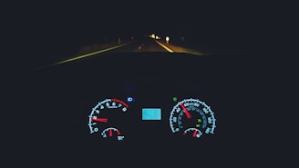 A sleek modern car dashboard with a glowing speedometer at dusk.