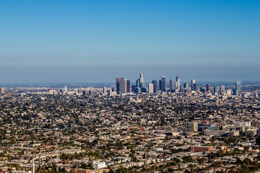 A vibrant downtown commercial district with office buildings and retail spaces under a clear blue sky.
