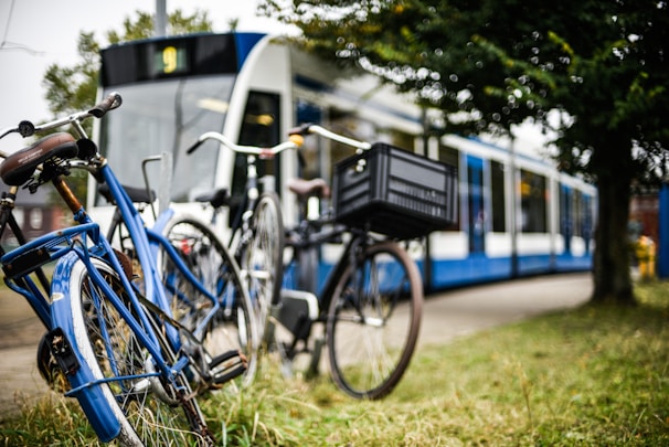 Bicycles parked near a tram stop in an urban setting.