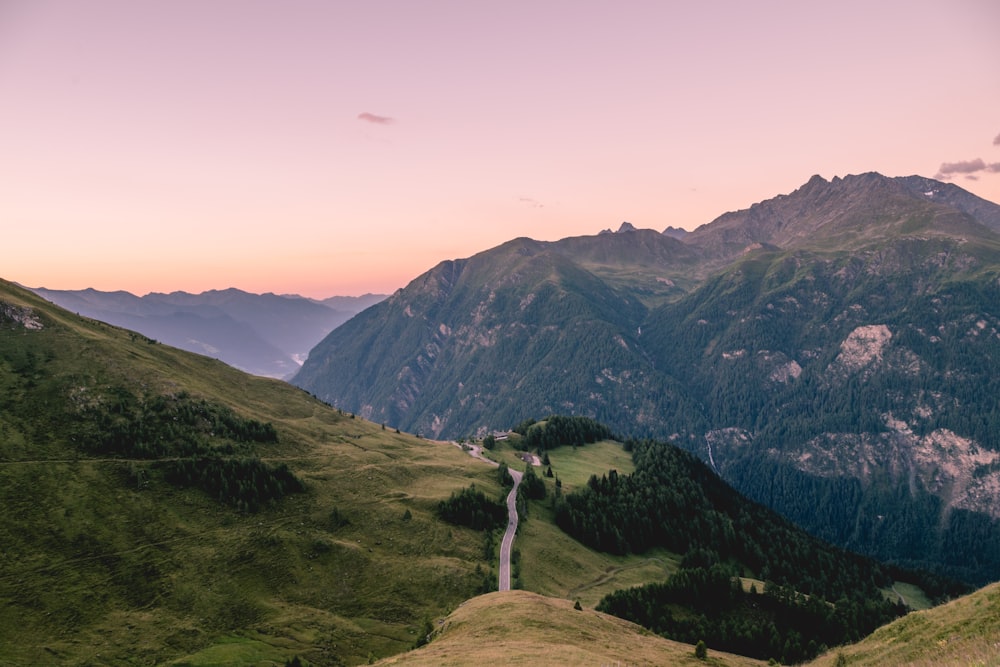 green mountains under orange sky during daytime