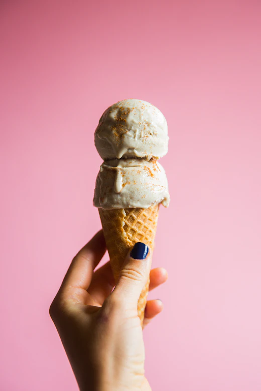 Vanilla bean ice cream scoops on a cone