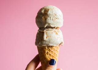 person holding ice cream on cone