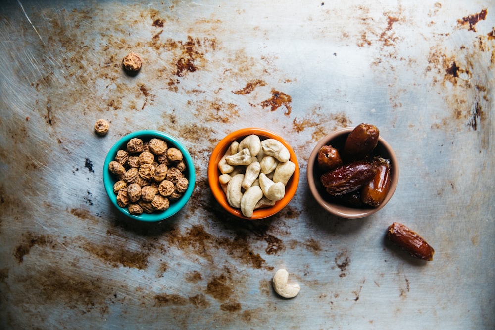 Small bowls of nuts, cashews, and dates for snack