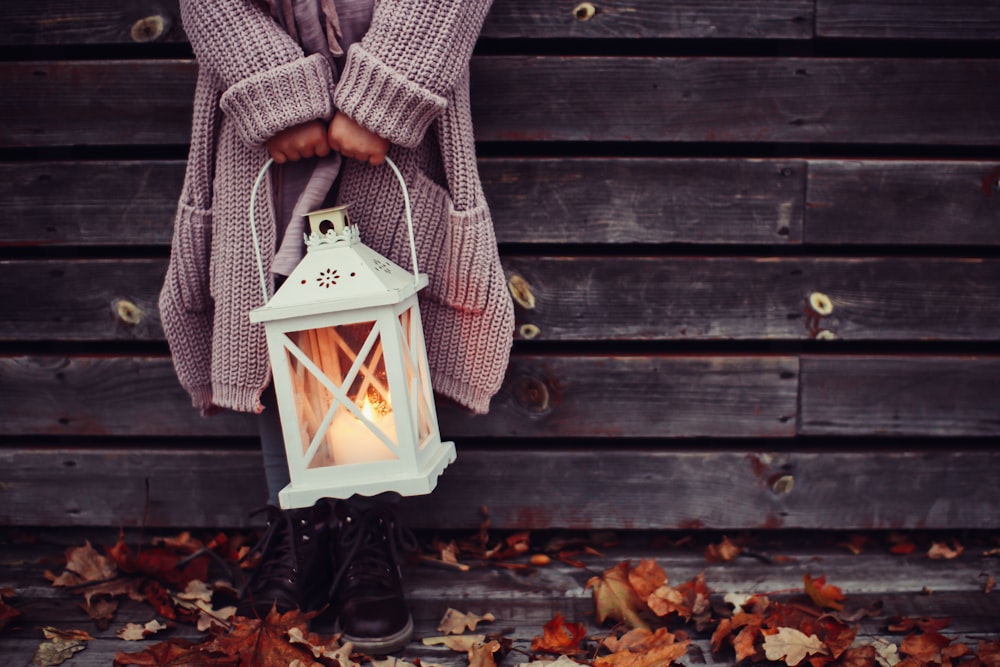 girl holding candle lantern