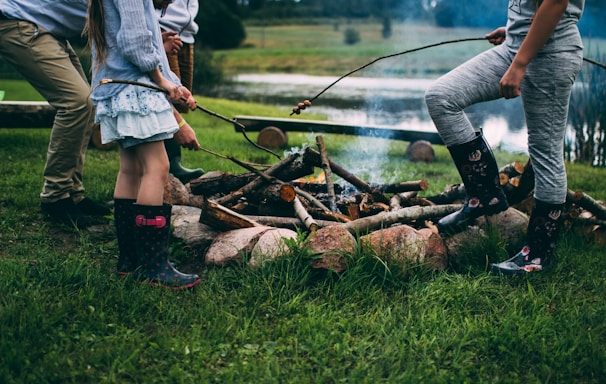 family camping near body of water during daytime