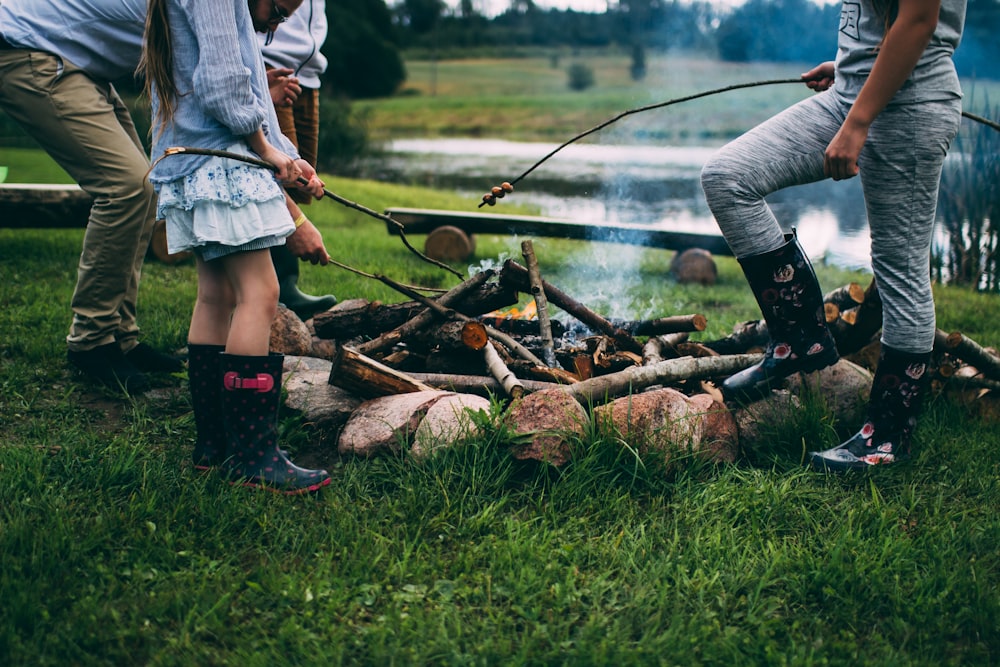 family camping near body of water during daytime