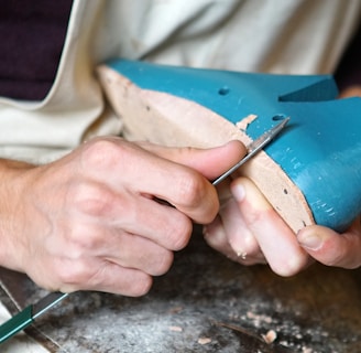 person carving blue footwear