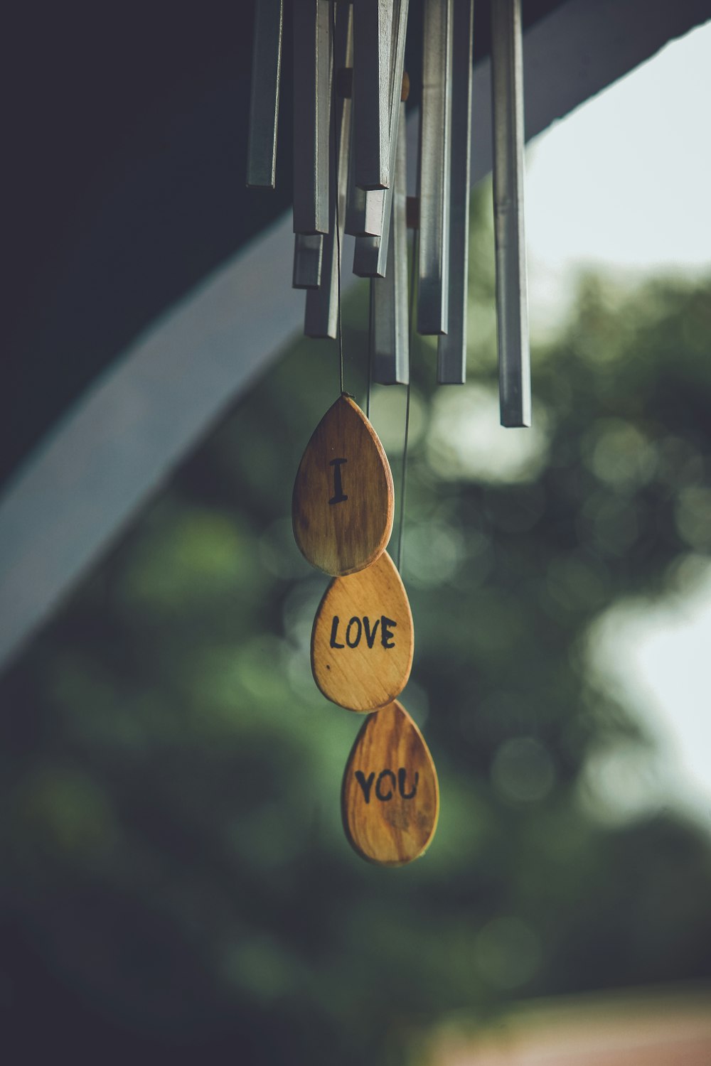 focus photography of gray and brown wind chimes