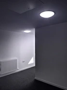 A pristine, white carpet being gently cleaned by a technician in a minimalist home.