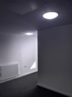 A modern minimalist space showcasing a neutral-toned flatweave carpet with subtle geometric designs.