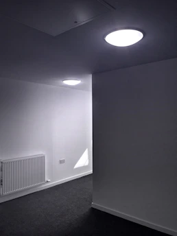 A pristine, white carpet being gently cleaned by a technician in a minimalist home.