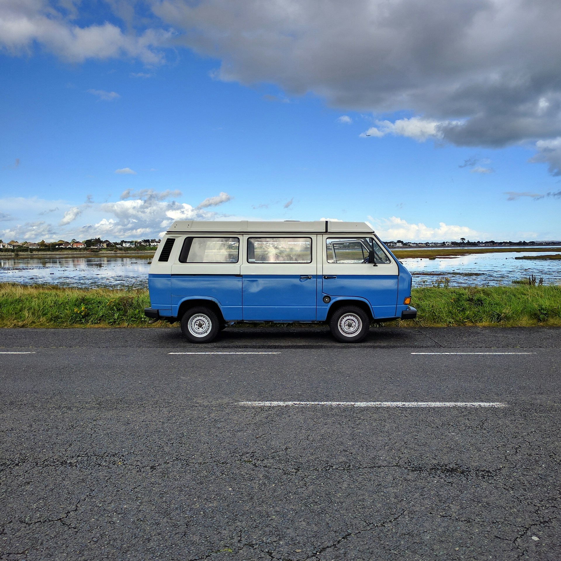woman wearing yellow long-sleeved dress under white clouds and blue sky during daytime