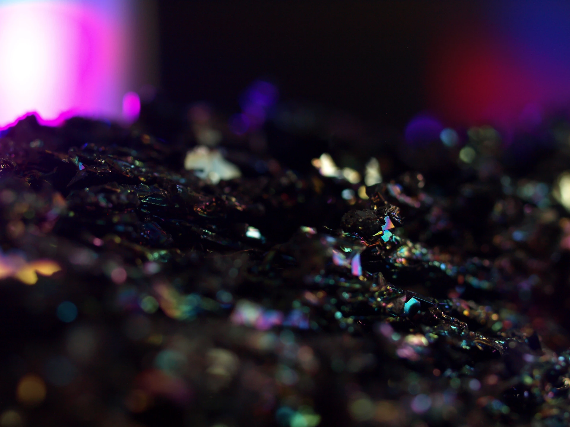 An artistic close-up of a textured mineral surface illuminated with soft, moody lighting to reflect the brand's exclusive and refined aesthetic.