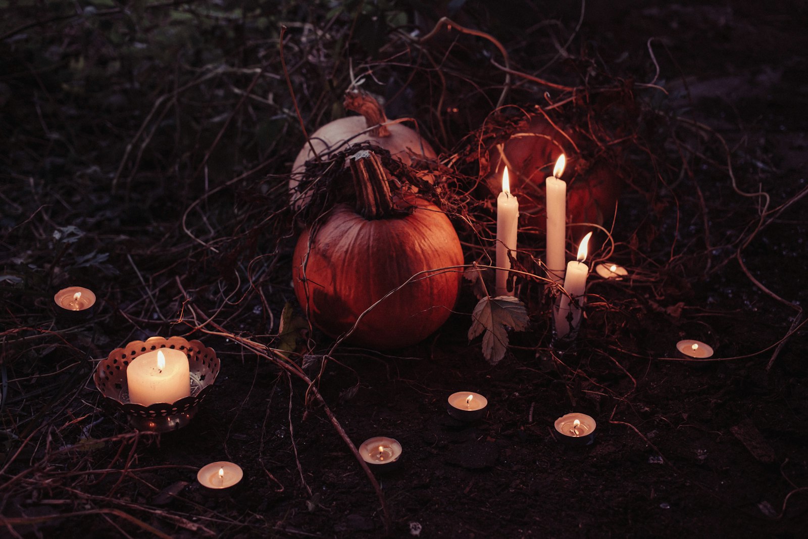 Canon EOS 6D + Canon EF 40mm F2.8 STM sample photo. Pumpkin between lighted candles photography