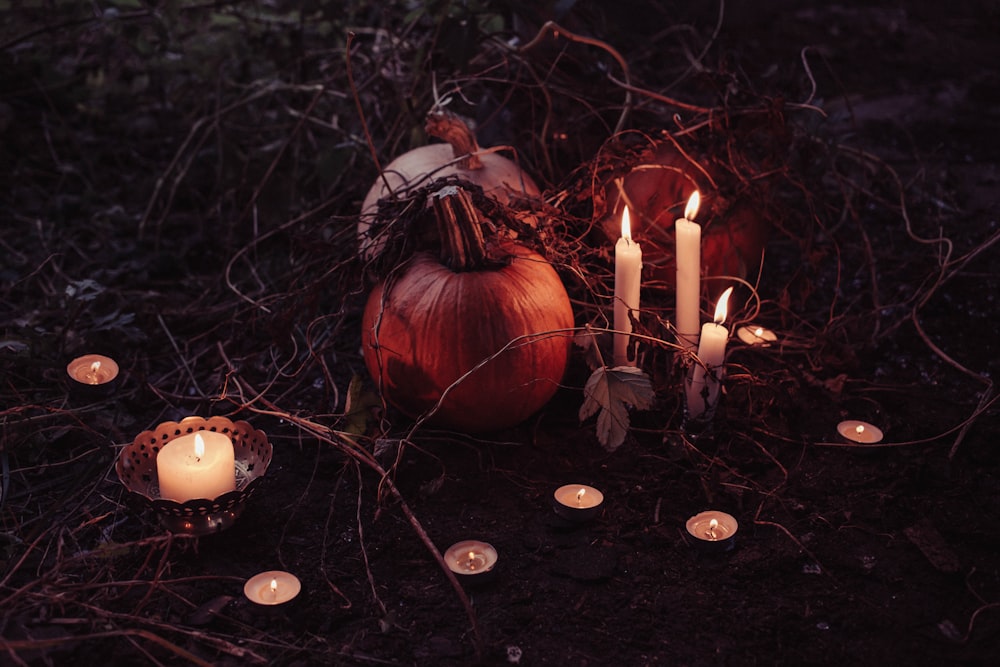 pumpkin between lighted candles