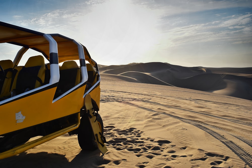 yellow and white UTV on desert