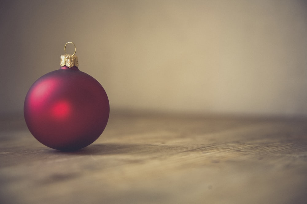 closeup photo of red ball ornament on surface
