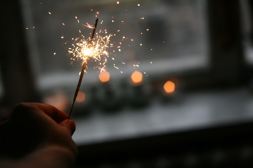 person holding sparkler