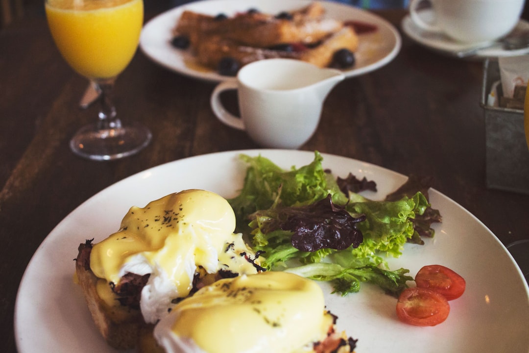 salad on white ceramic plate on table, Eggs Benedict