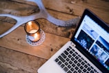 A rustic wooden table displaying elegant physical and digital products under soft warm lighting.