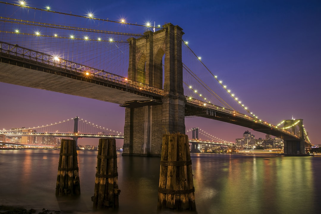 Brooklyn bridge with lights at night time,