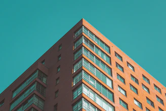 Close-up of a modern Chicago apartment building facade, showcasing clean lines and red accents.