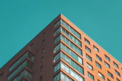 Close-up of a modern Chicago apartment building facade, showcasing clean lines and red accents.