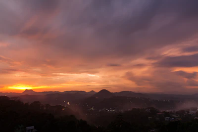 Sunset over the ancient terraces of Machu Picchu with vibrant orange skies.