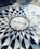 Mosaic pavement featuring the word 'IMAGINE' at its center, surrounded by a circular pattern of geometric shapes in black and white.
