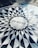 Mosaic pavement featuring the word 'IMAGINE' at its center, surrounded by a circular pattern of geometric shapes in black and white.
