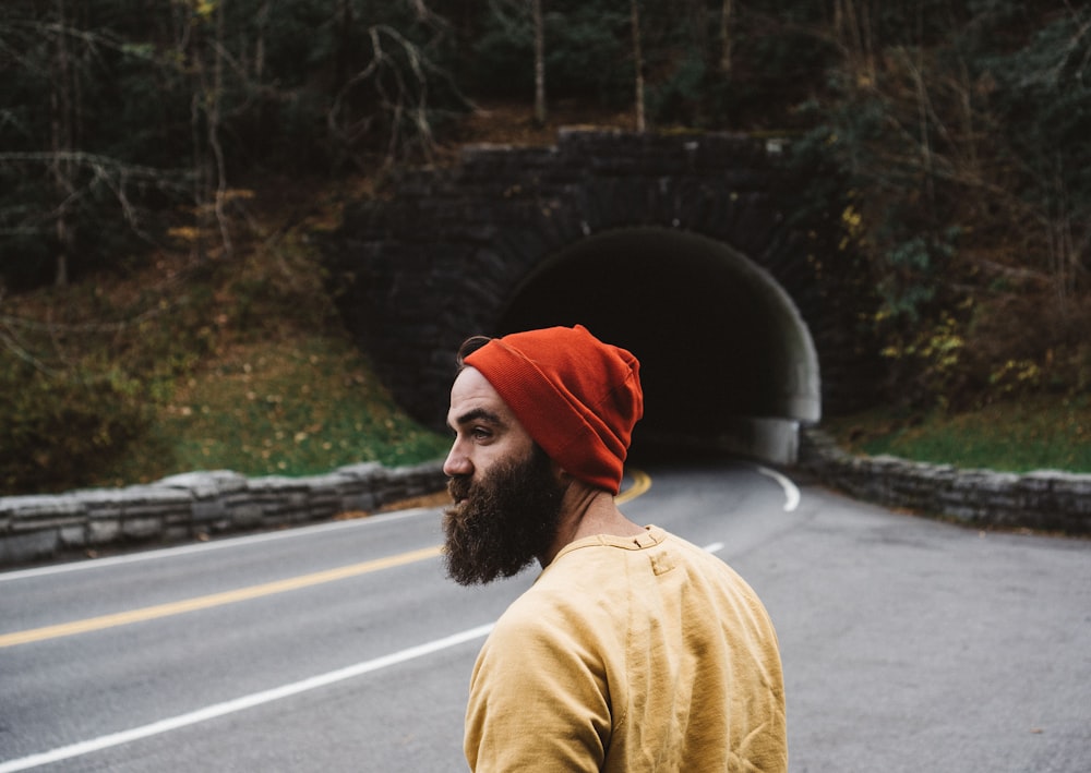 man standing near road during daytime