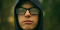selective focus photography of man wearing eyeglasses